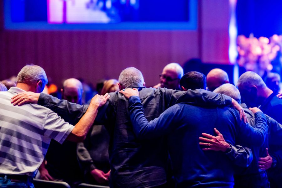 Group with arms around each other